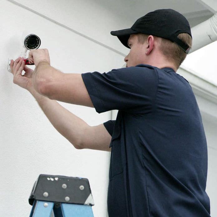 Security tech installing camera