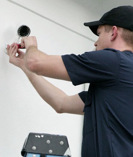 Security technician installing a camera